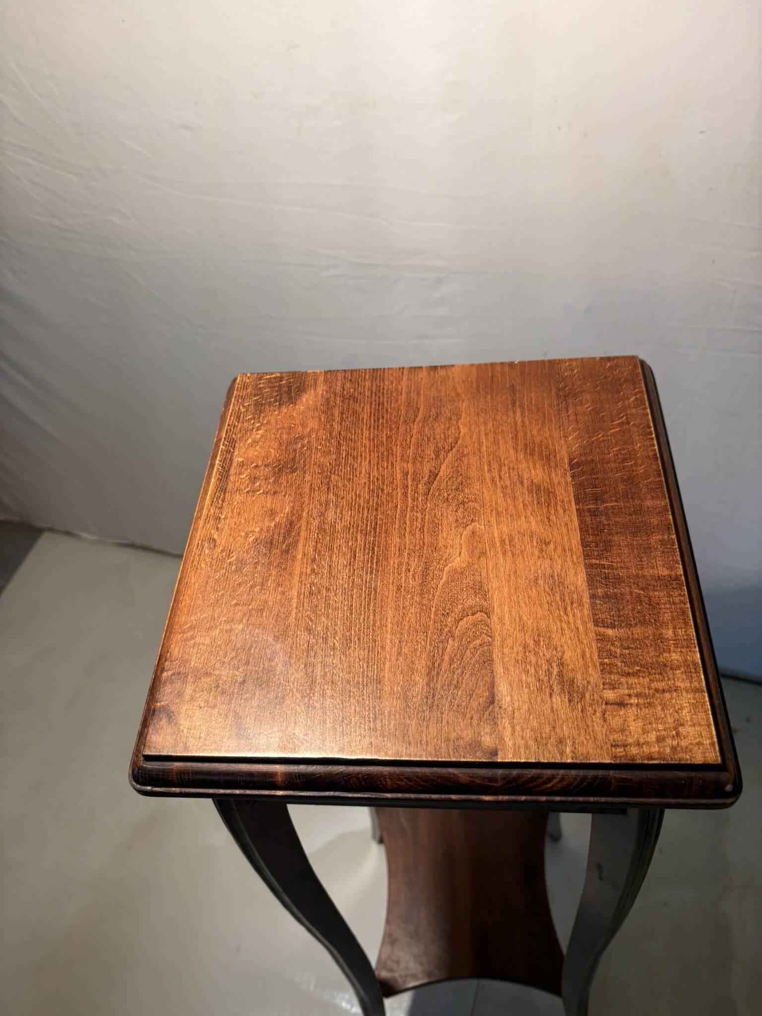Vintage dark wood side table with curved base