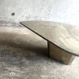Light gray solid granite coffee table with organic triangular shape and conical base, 1980s