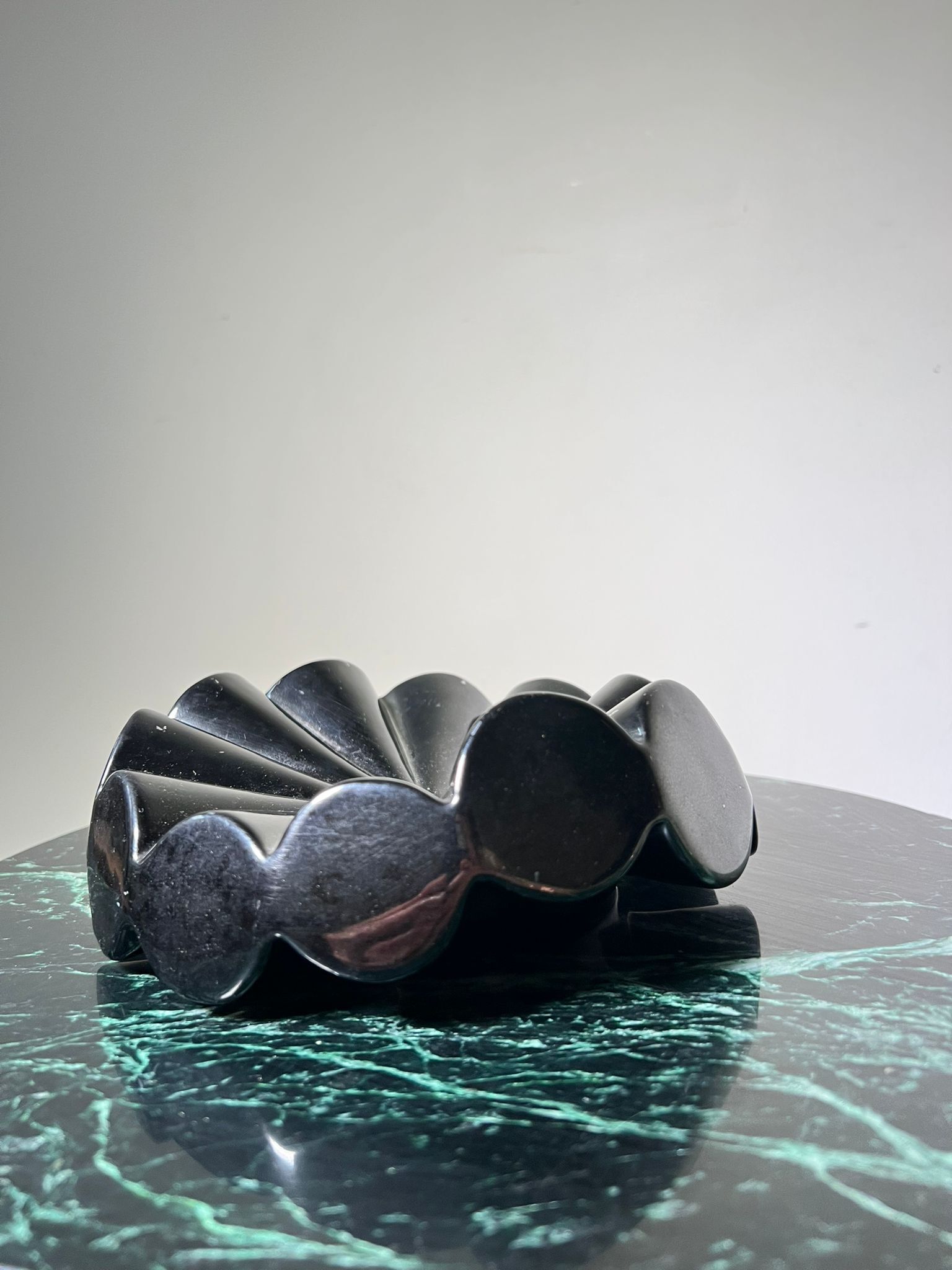 Empty pocket black glazed ceramic ashtray, 1970