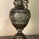 Bronze vase with snakes and a green patina, in the antique style.