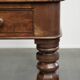 Antique English writing desk from the 19th century with a red leather top