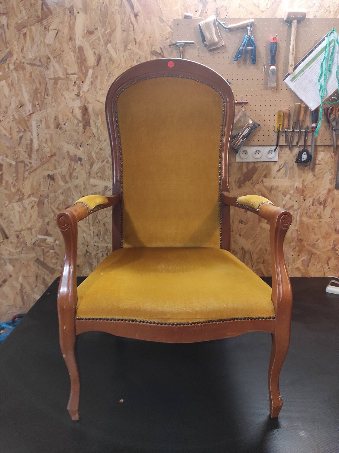 Renovated Voltaire armchair with boucle fabric.