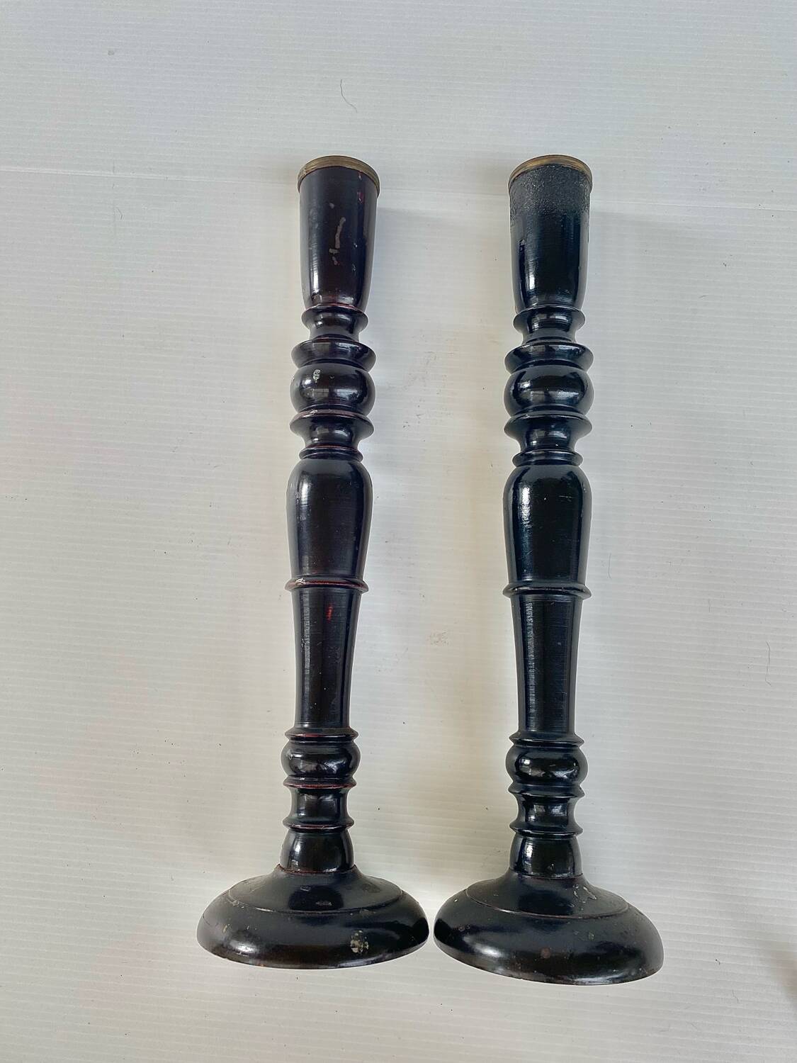 Pair of antique ebonised wooden candlesticks from the 19th century.