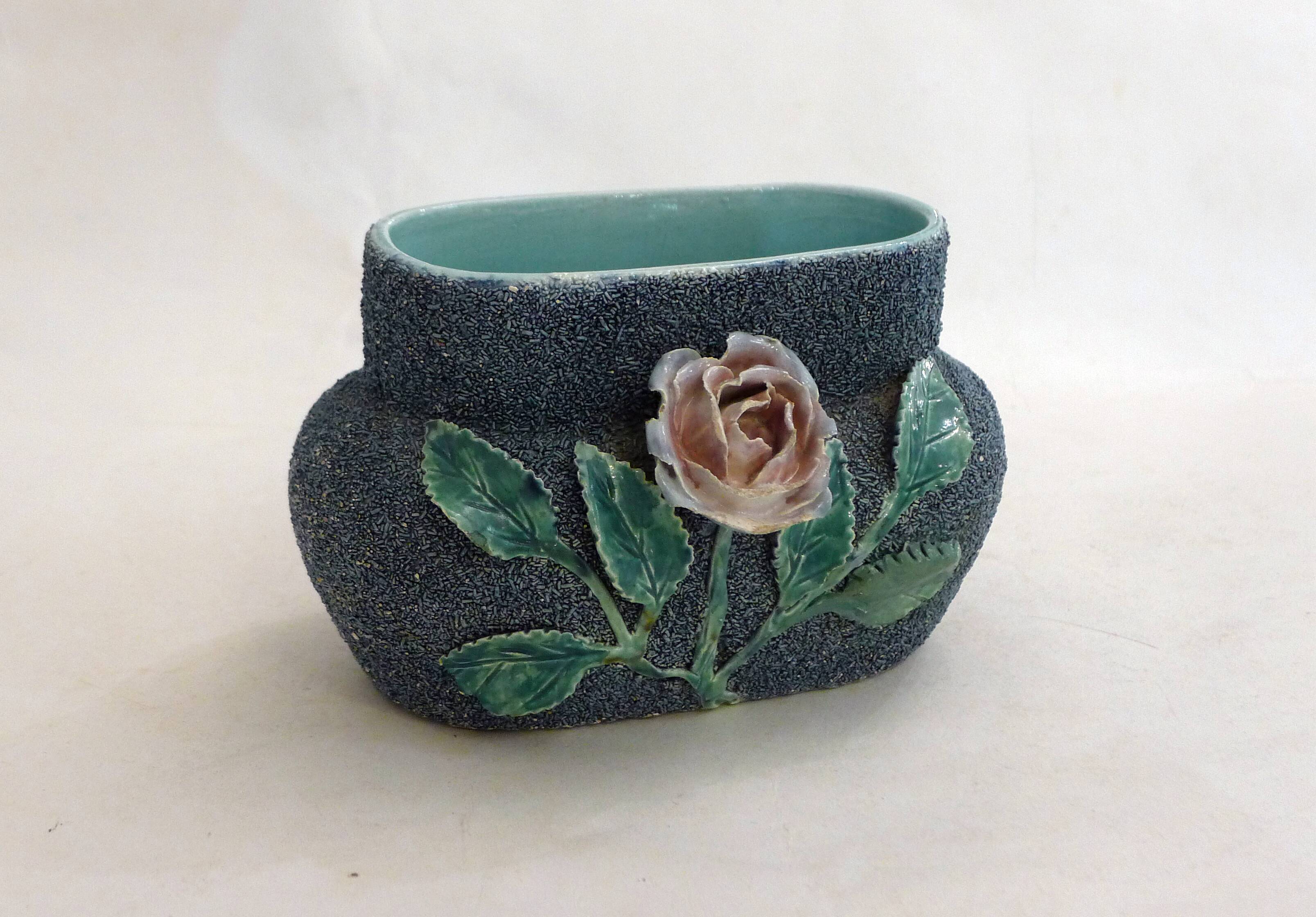 Antique jardinière with rose design in barbotine pottery.