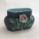 Antique jardinière with rose design in barbotine pottery.