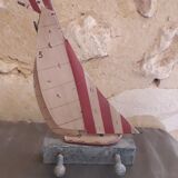 Wooden and metal hook in the shape of a sailboat