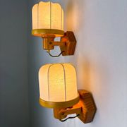 Pair of articulated "Cocoon" wall lights, resin and pine, Italy, circa 1970