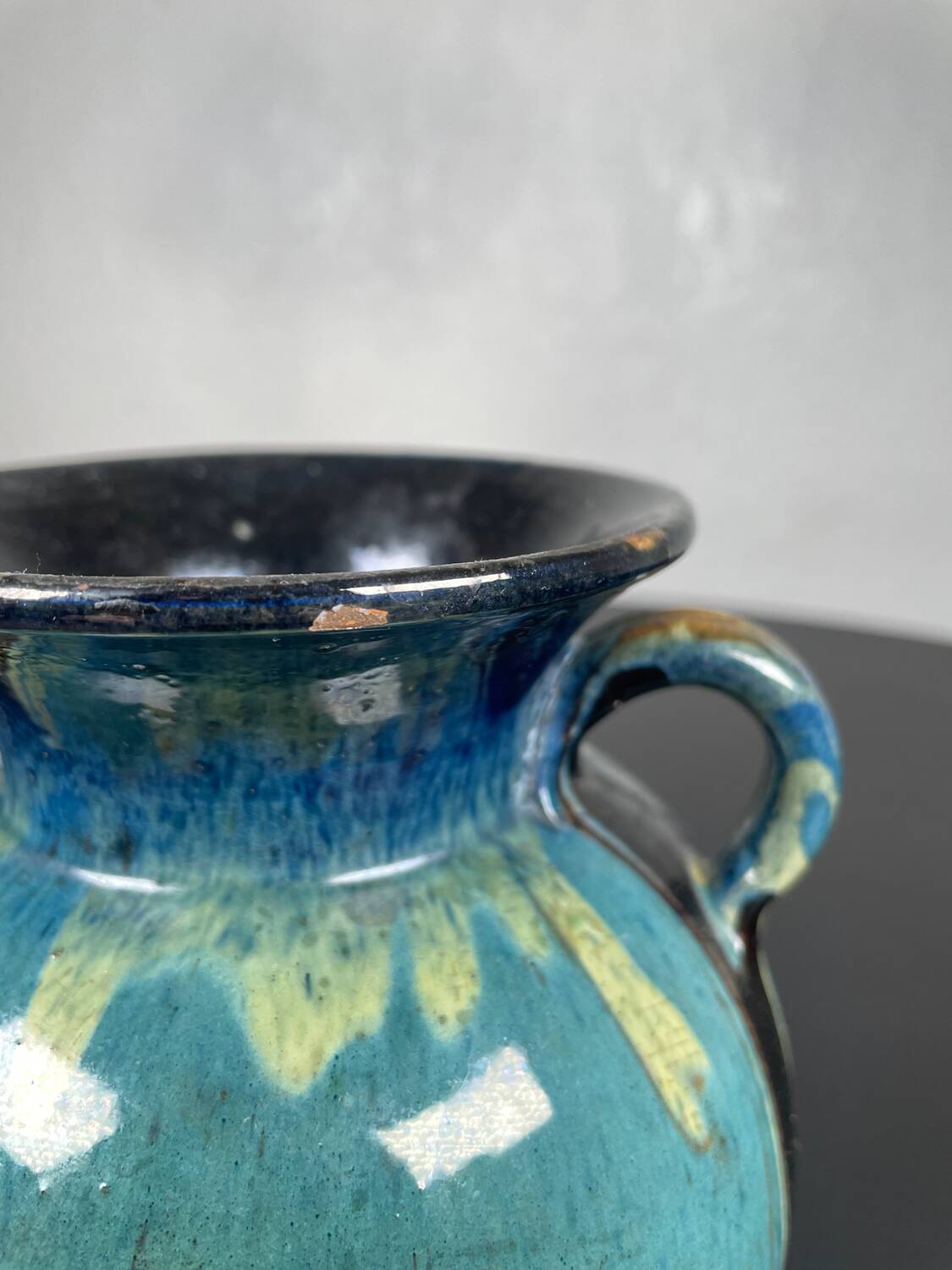 Black ball vase with handle, yellow blue marbled