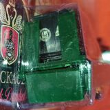 Mercedes flatbed containing drums pulling 1 trailer carrying 1 covered vehicle