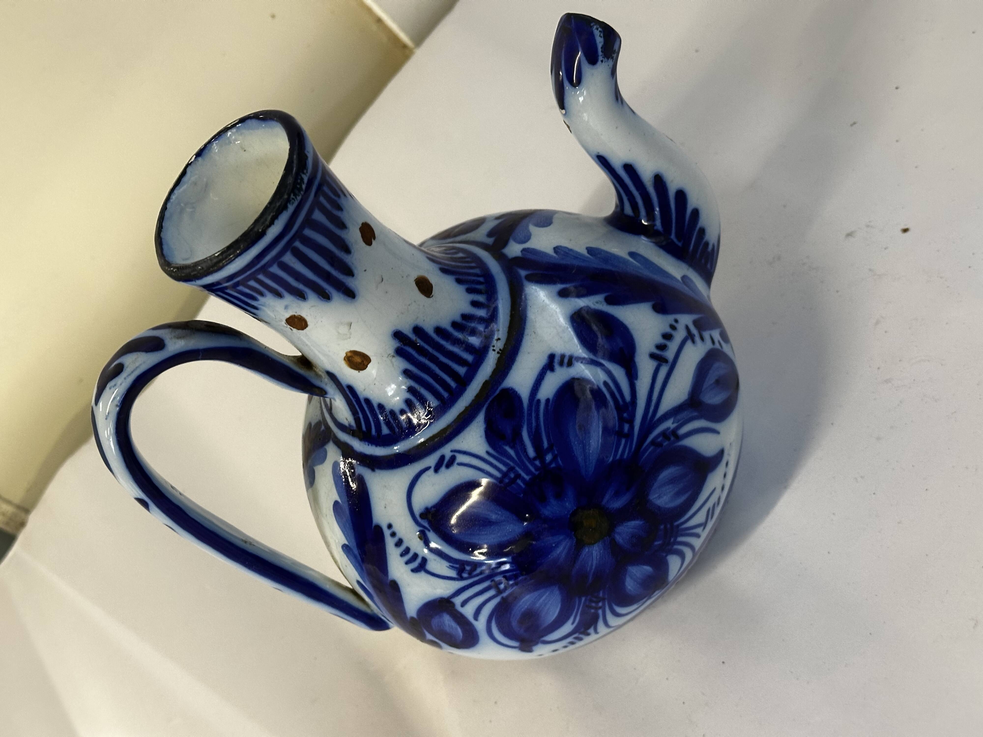 Glazed ceramic carafe with floral decoration