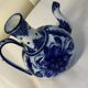 Glazed ceramic carafe with floral decoration