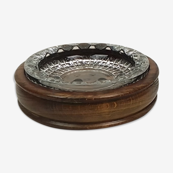 Glass ashtray on wooden support