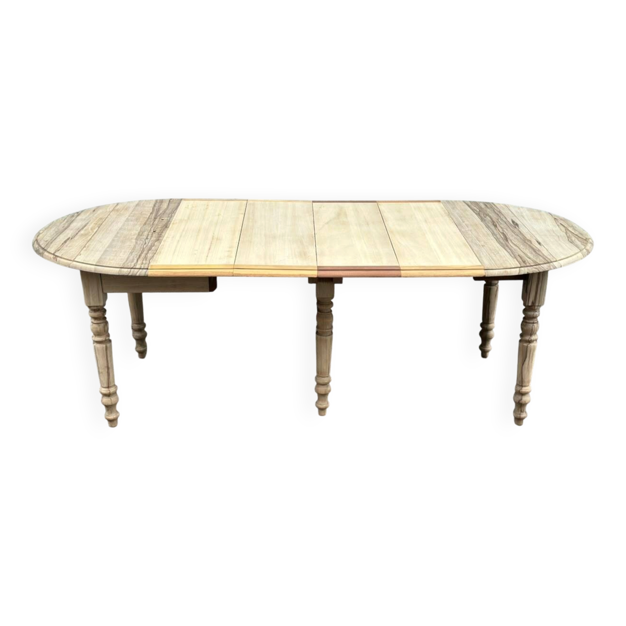 Round extendable dining table with flaps, stripped in raw oak, with 4 extensions.