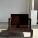 Small low armchair in varnished brown wood