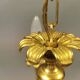 Older brass alloy chandelier with three light sources.