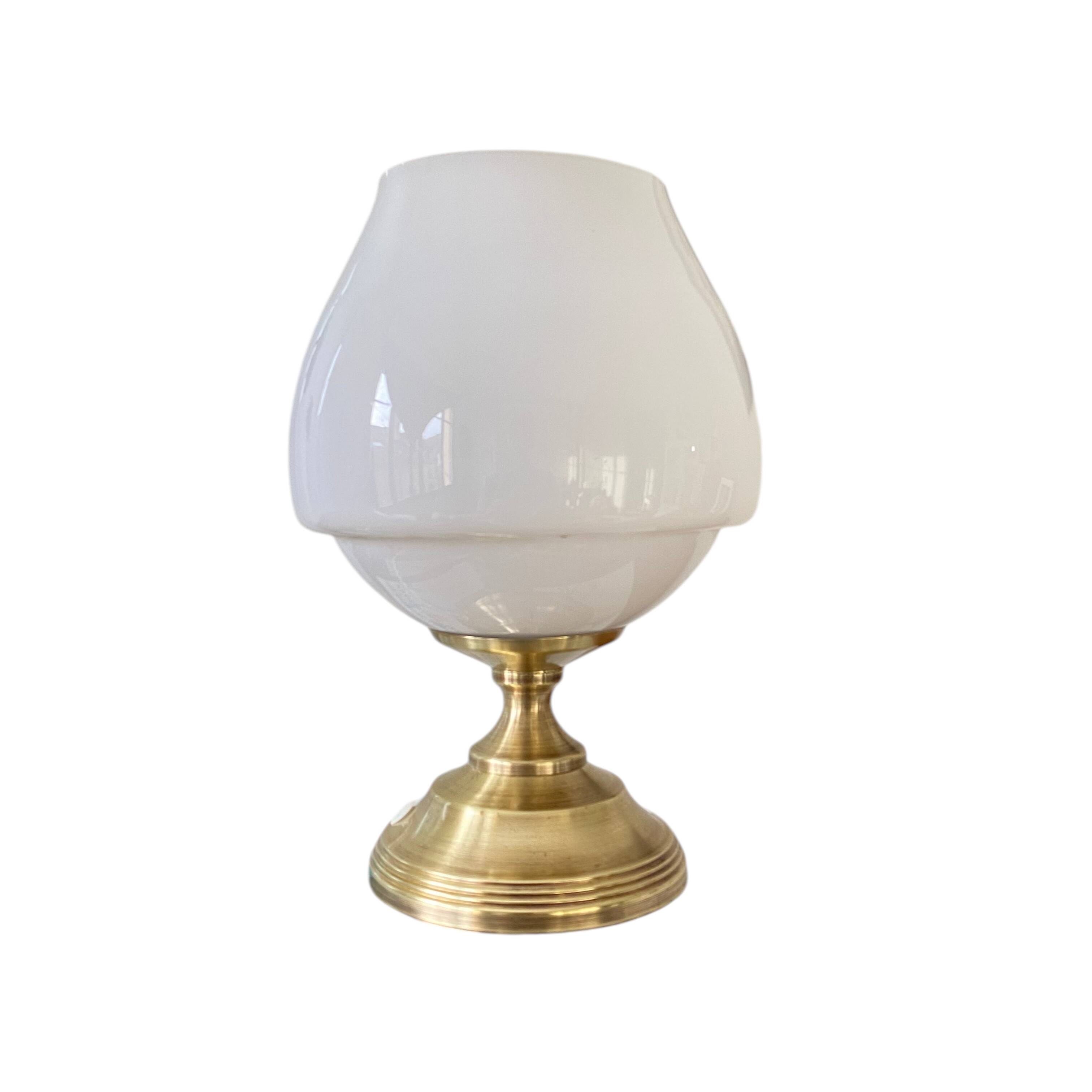 Antique white opaline glass globe table lamp with a brass base.