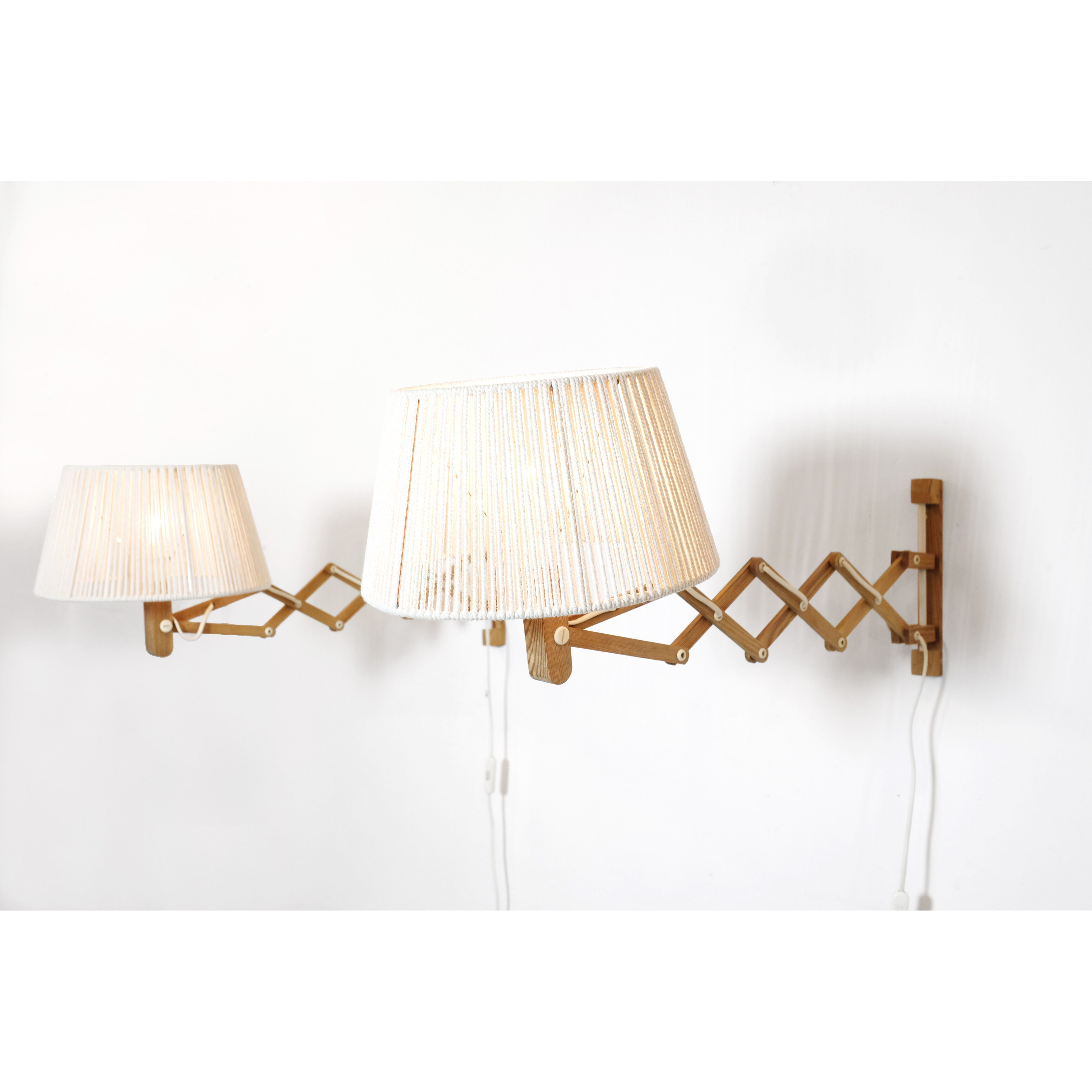 Pair of pine accordion sconces with cotton rope lampshade.