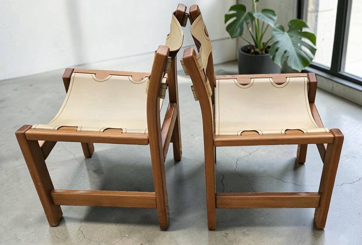 Pair of elm and leather chairs by Maison Regain
