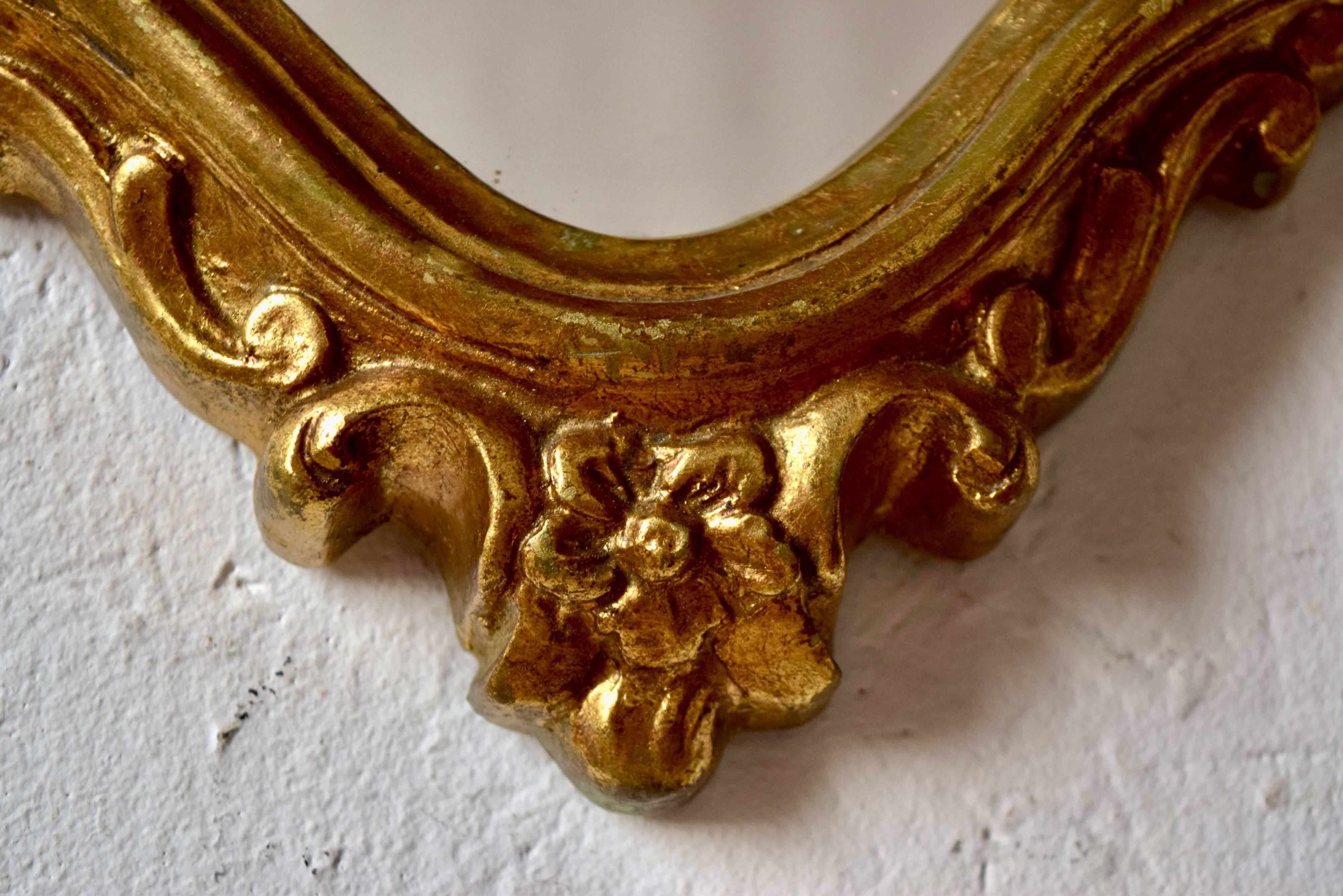 Large rococo mirror in gold painted wood