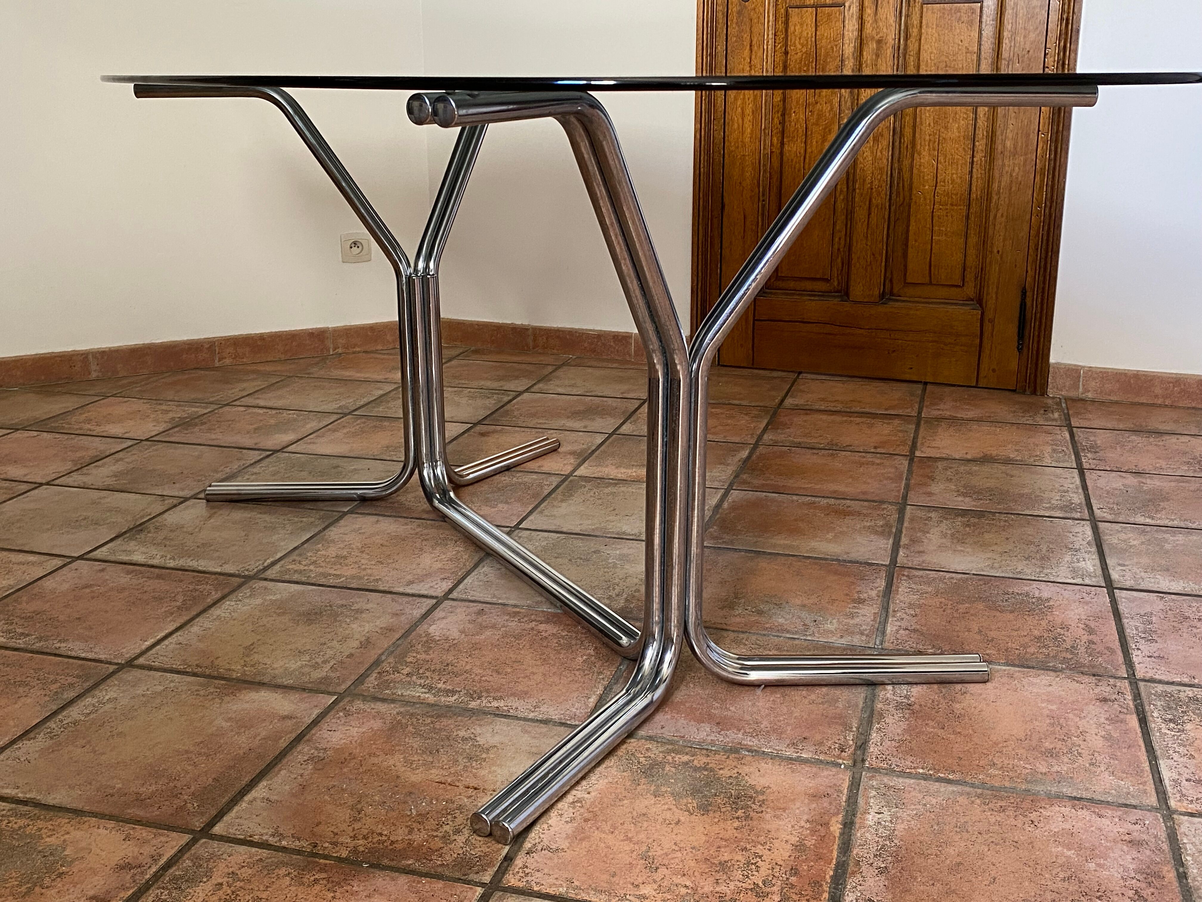 Oval table. 1970. Steel and smoked glass. 180x100