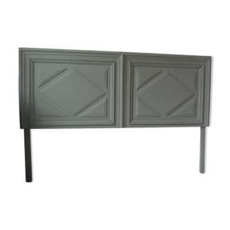 Headboard made with an old walnut door, re-enchanted in gray green waxed finish,