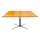 Table rises and lowers in light wood and metal.