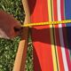 vintage wooden deck chair with red, blue, and yellow striped fabric