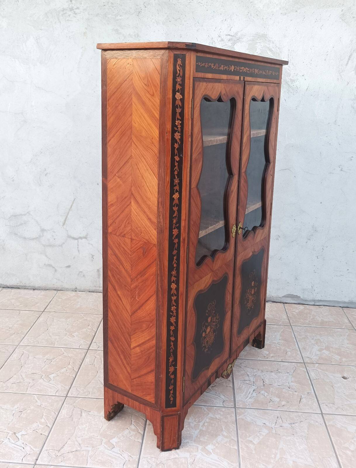 Louis XVI glass-fronted library in rosewood and amaranth veneer.