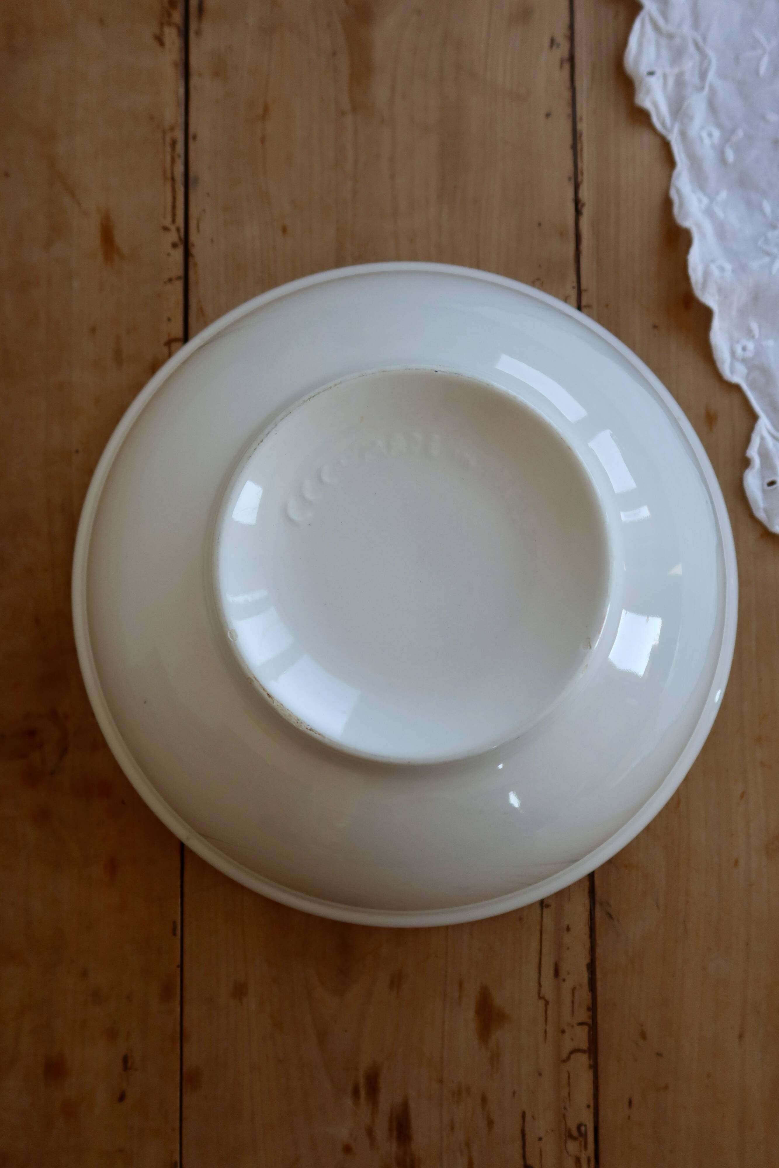 Vintage porcelain salad bowl with multicoloured borders.