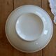 Vintage porcelain salad bowl with multicoloured borders.