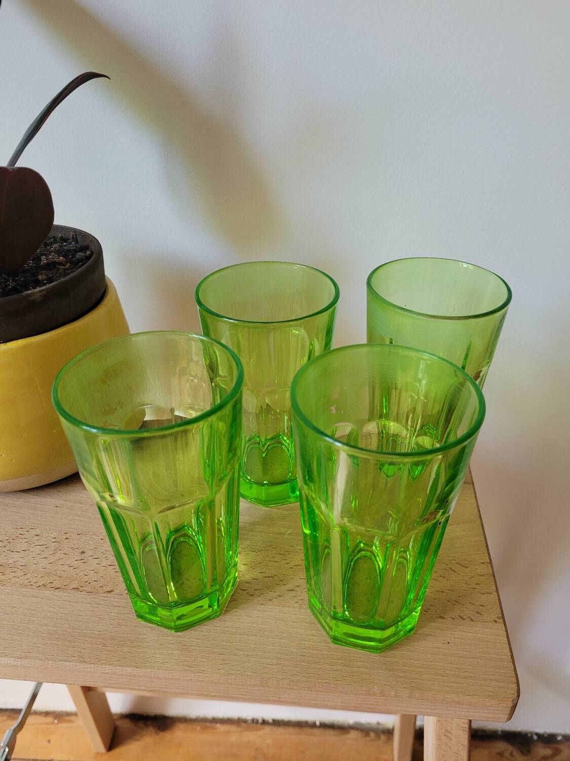 Four neon green lemonade glasses