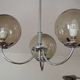 Chrome metal chandelier with smoked glass globes.