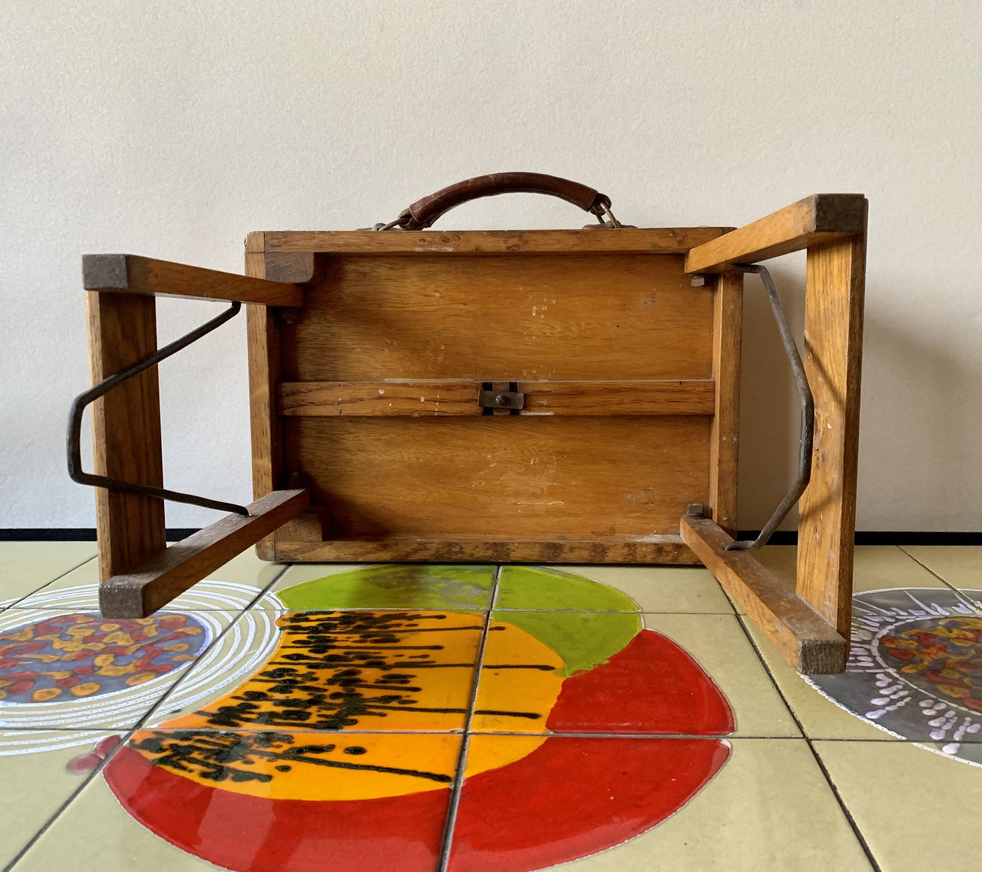 Old foldable fisherman's stool in wood and leather
