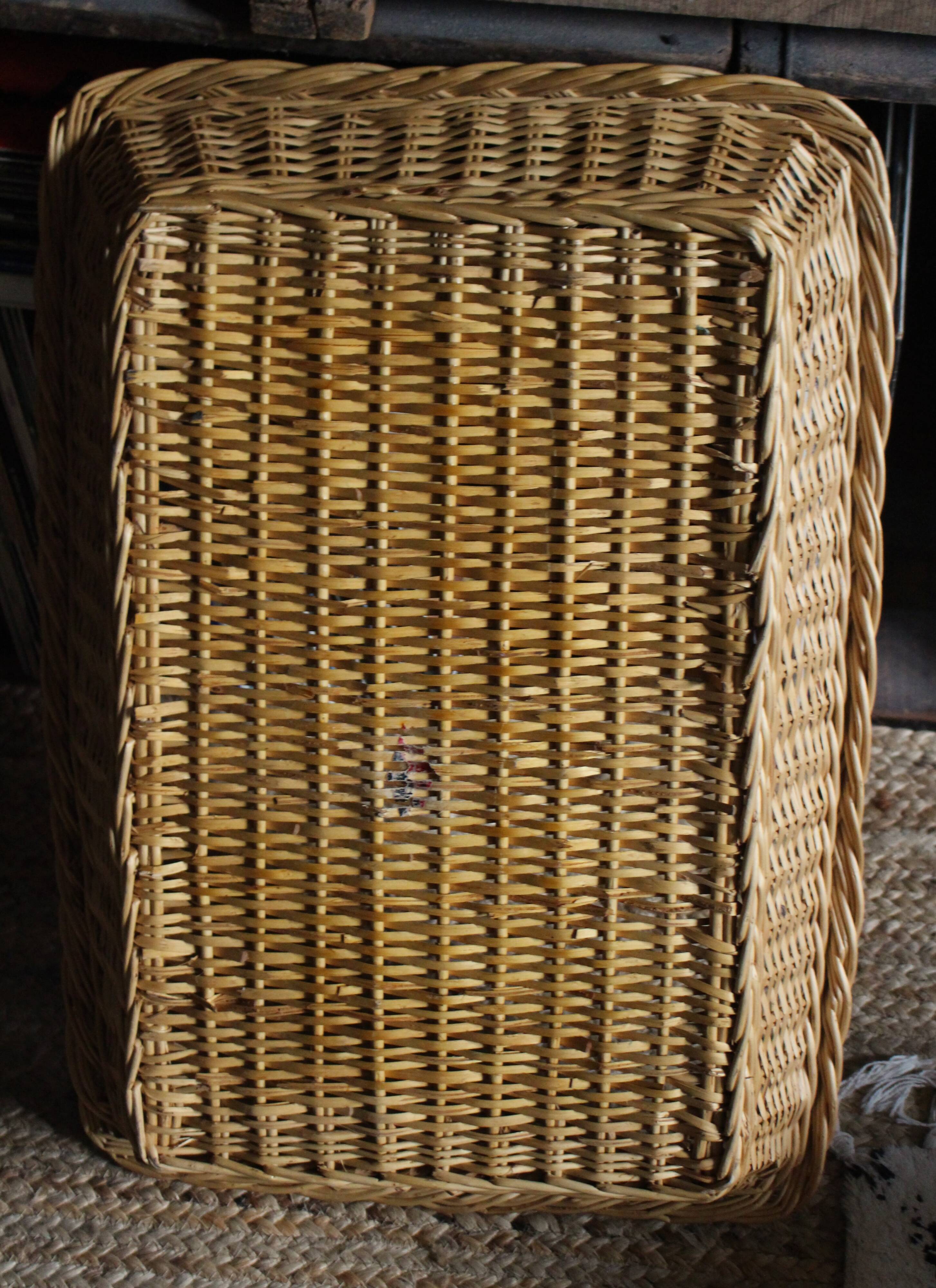 A large vintage rectangular wicker basket
