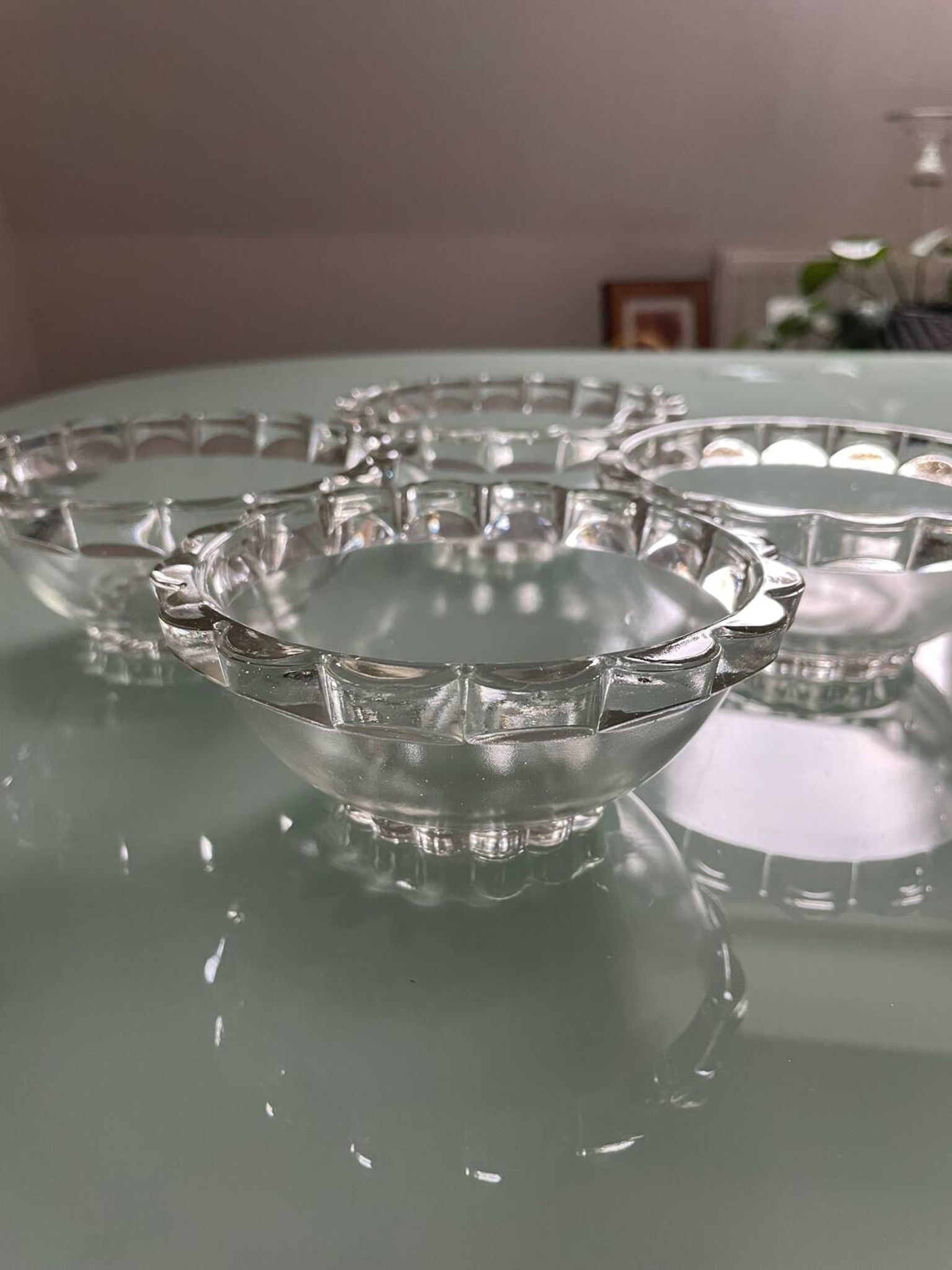 Four vintage clear glass bowls.
