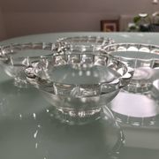 Four vintage clear glass bowls.
