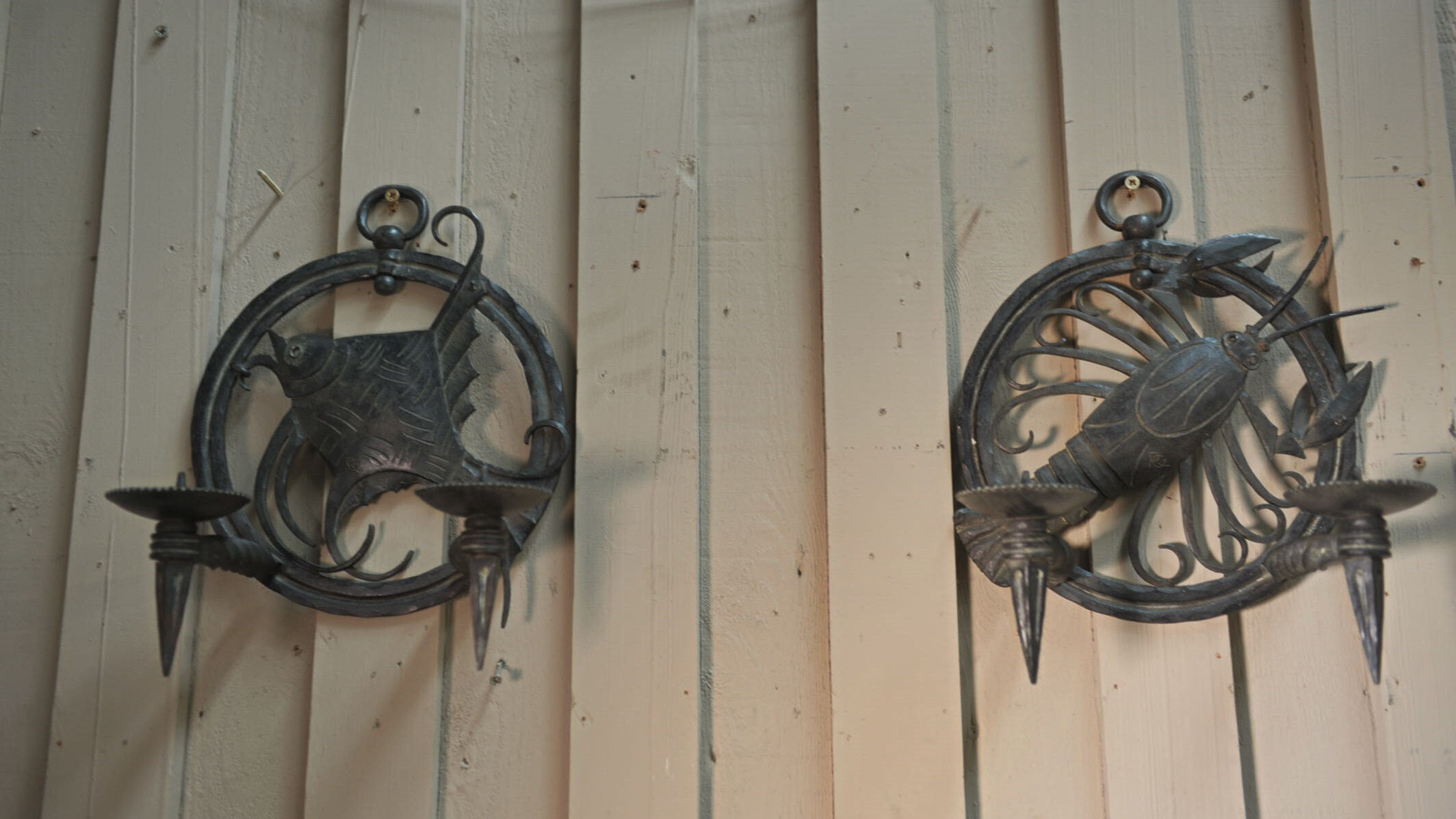 Pair of carved metal wall lamps signed RG