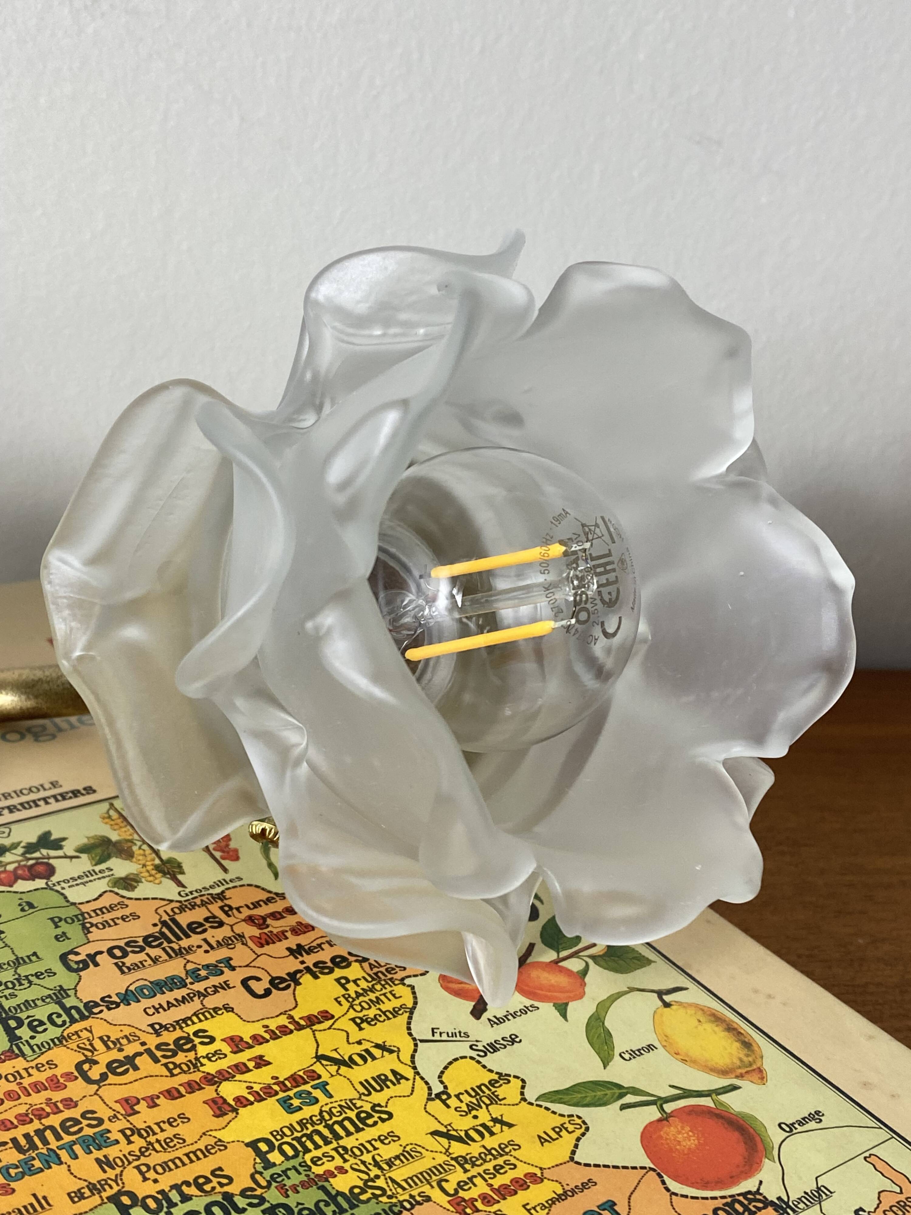 Swan neck wall light in brass with rose petal glass shade.