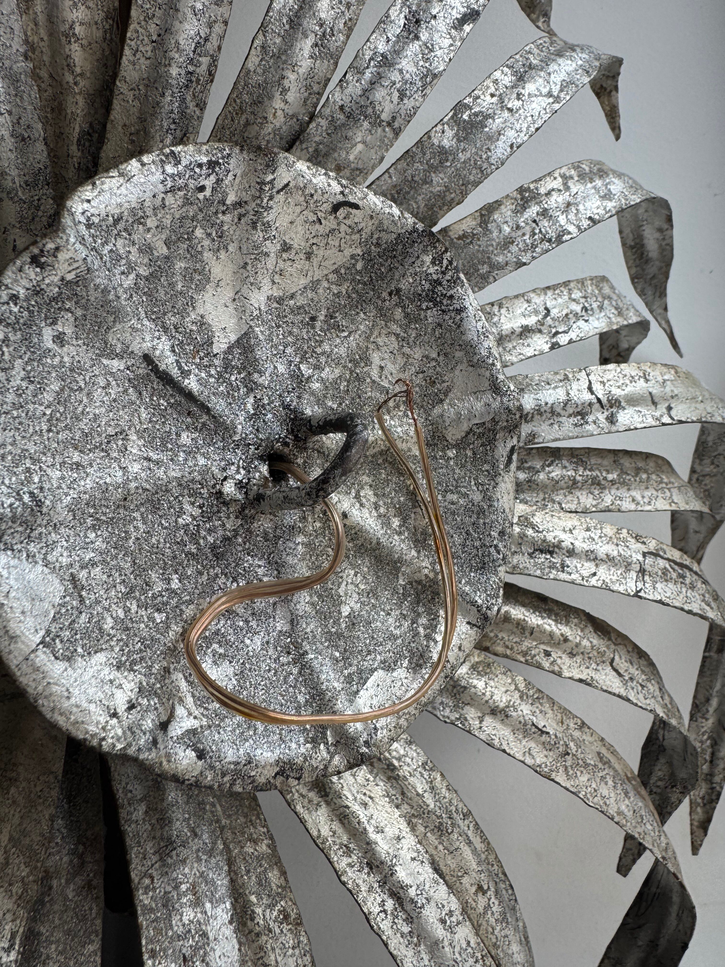 Silver wrought iron sunburst wall light from the 1960s.