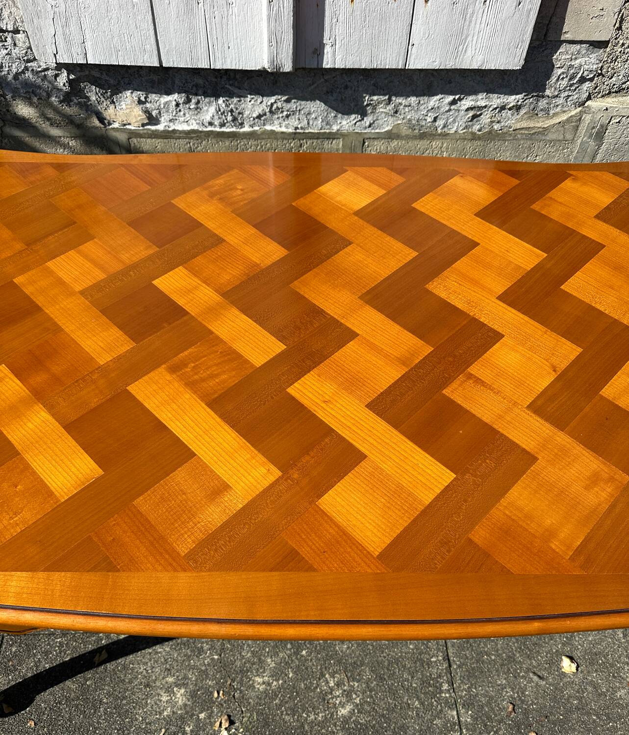Antique extendable table in cherry wood and marquetry in the Louis XV style.