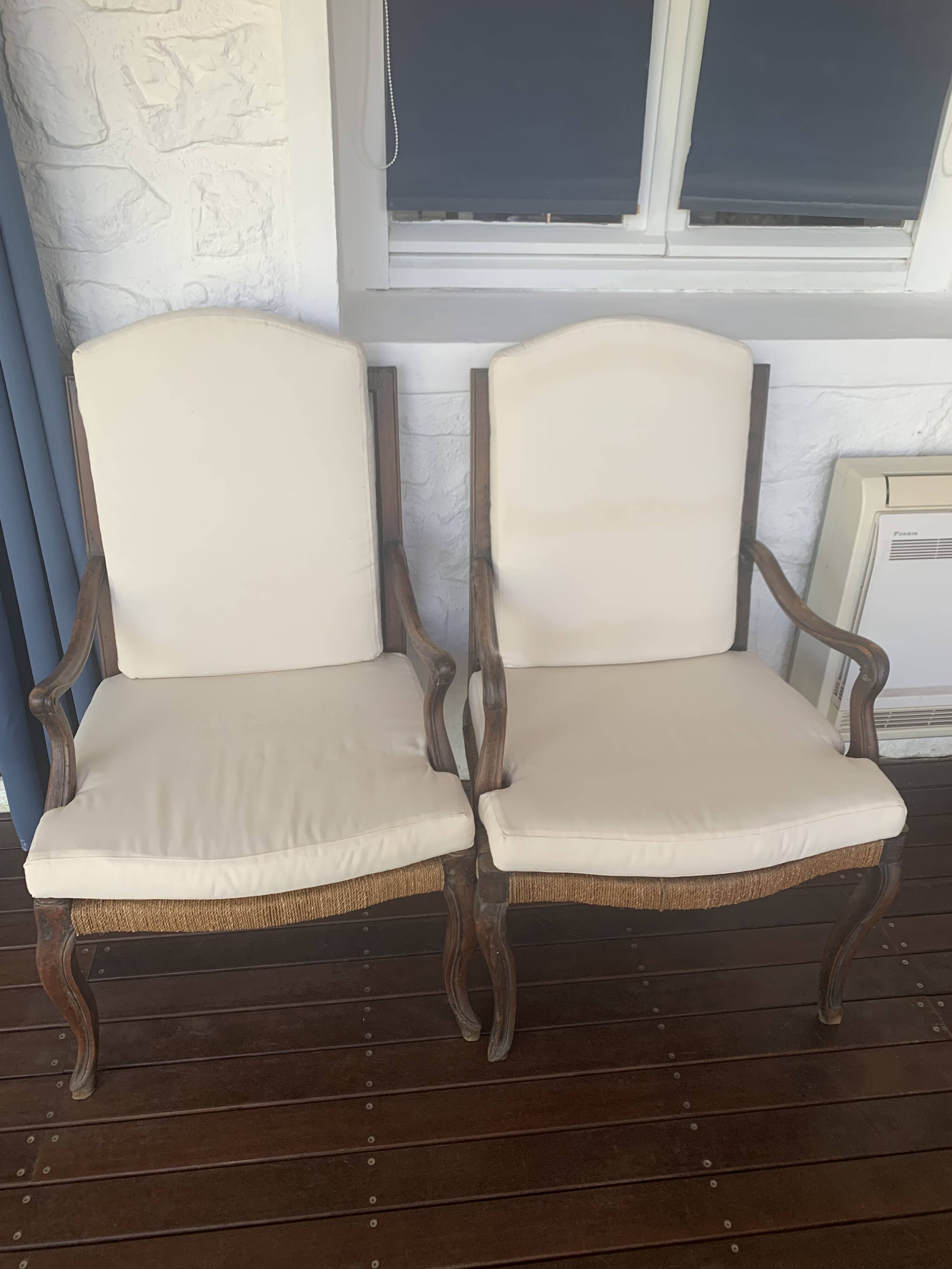 Pair of antique wooden armchairs with woven seats + cushions
