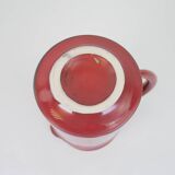 Red glazed ceramic jug with relief