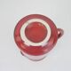 Red glazed ceramic jug with relief