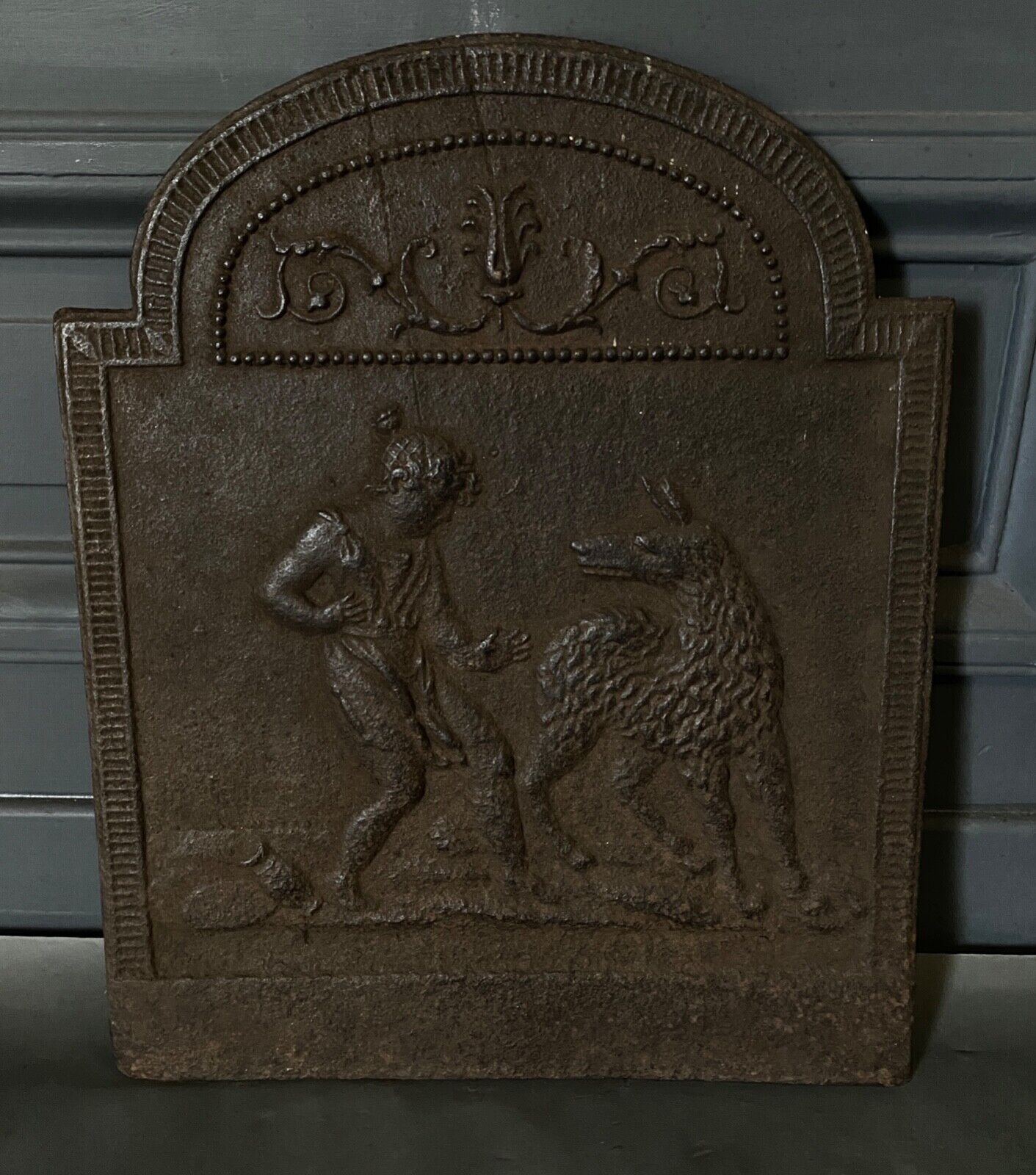 EIGHTEENTH CENTURY CAST IRON FIREPLACE PLATE REPRESENTING A WOMAN AND A WOLF
