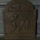EIGHTEENTH CENTURY CAST IRON FIREPLACE PLATE REPRESENTING A WOMAN AND A WOLF