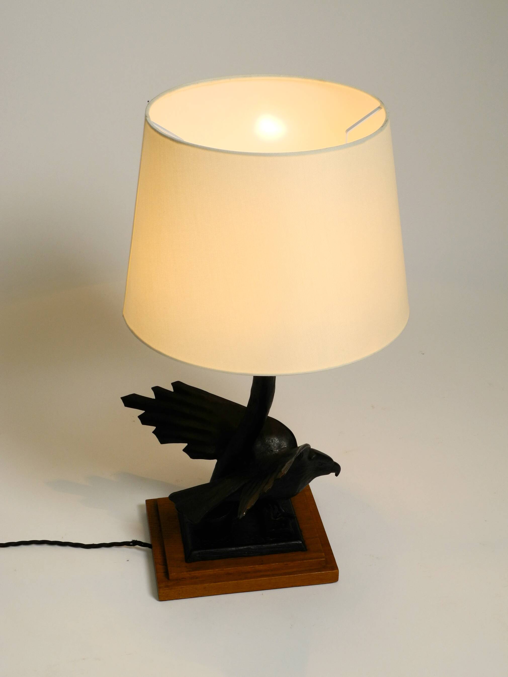1940s table lamp made of iron in the shape of an eagle, teak wooden base