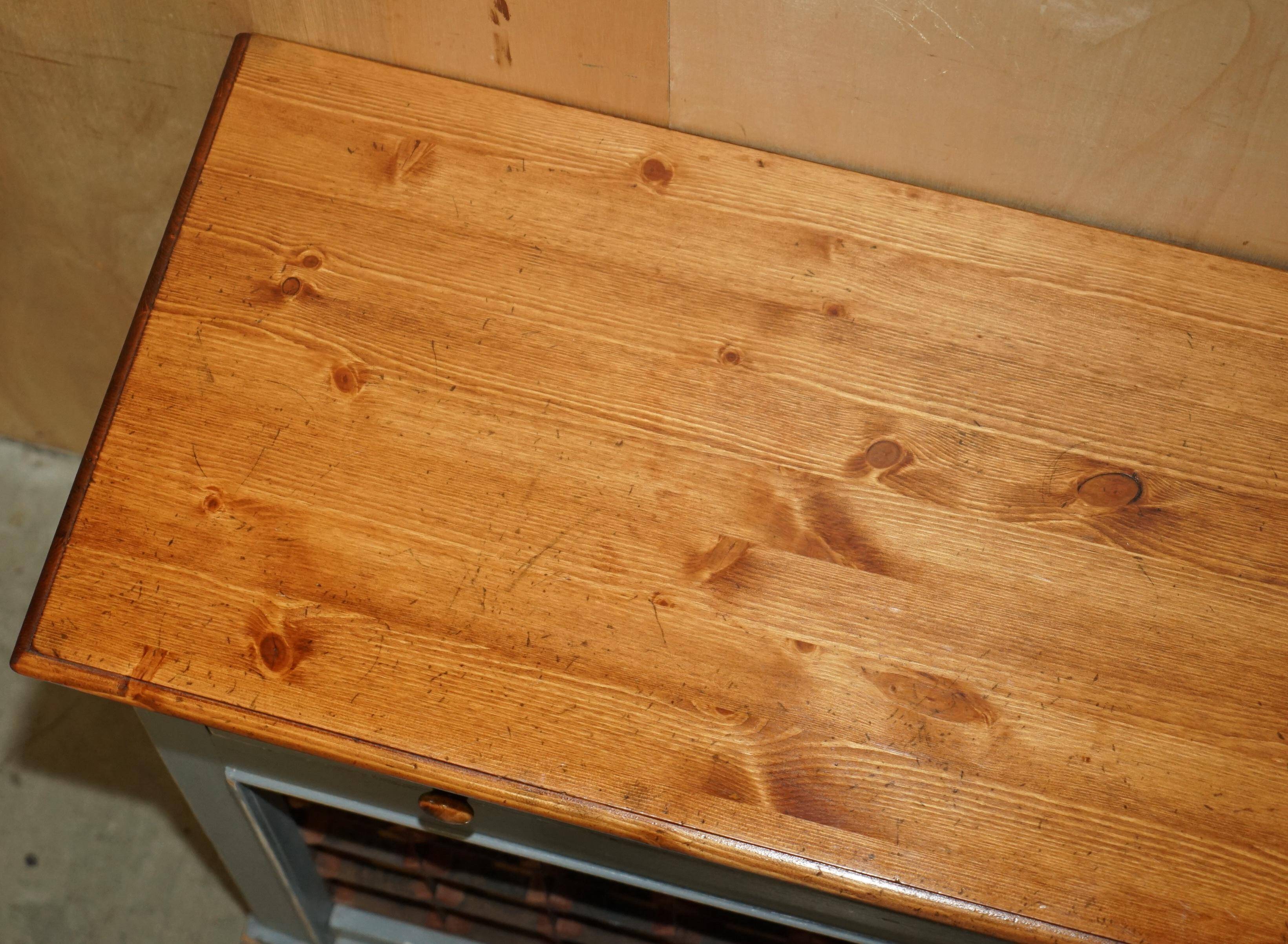 Vintage wooden furniture for 45 wine bottles with a drawer.