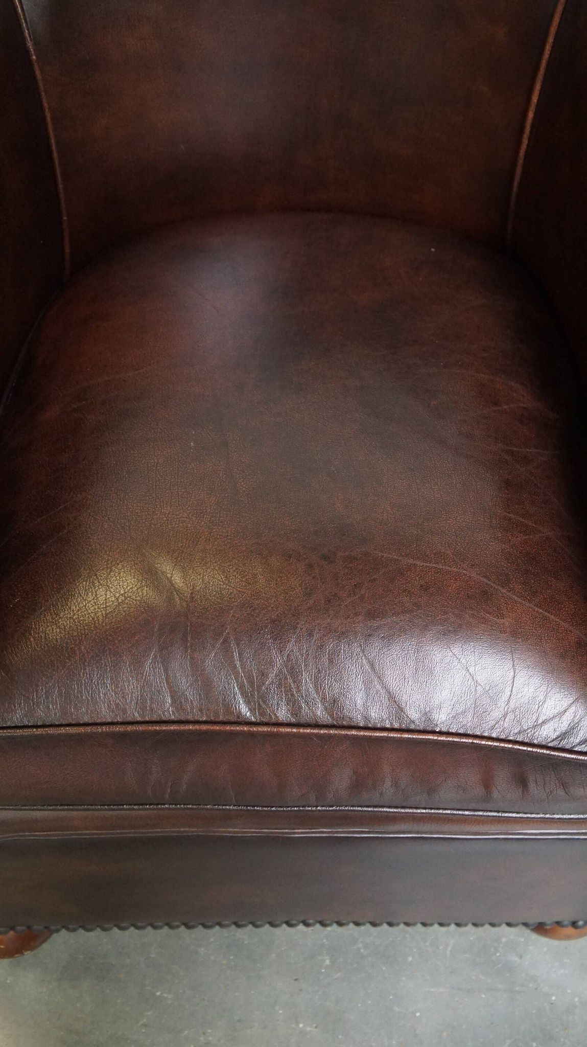 luxury dark leather club chair with English-style ball feet
