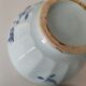 Two vintage farm bowls on a pale blue pedestal with floral decoration.