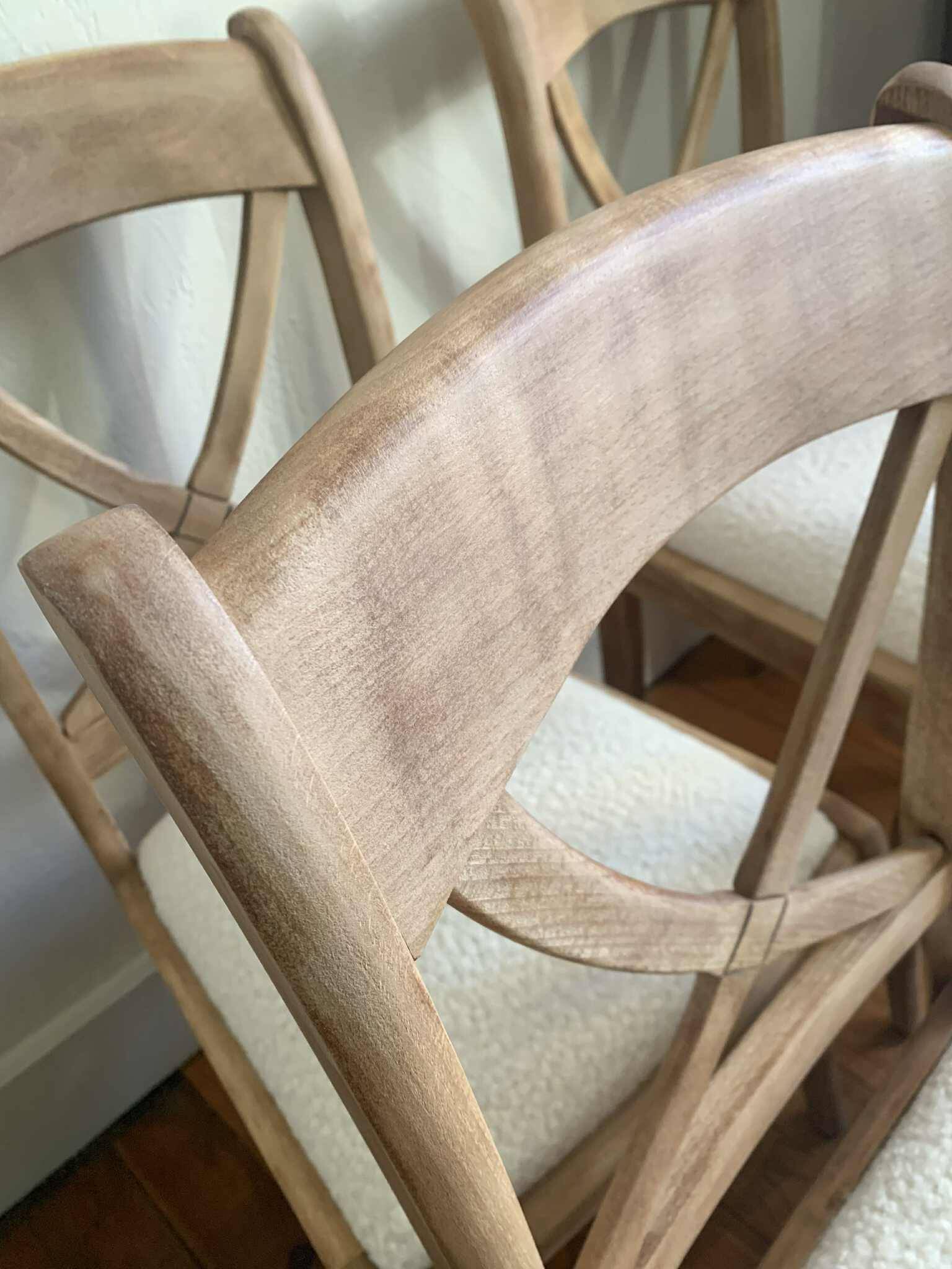 Set of 6 cross-back chairs in solid wood, with white boucle seats.